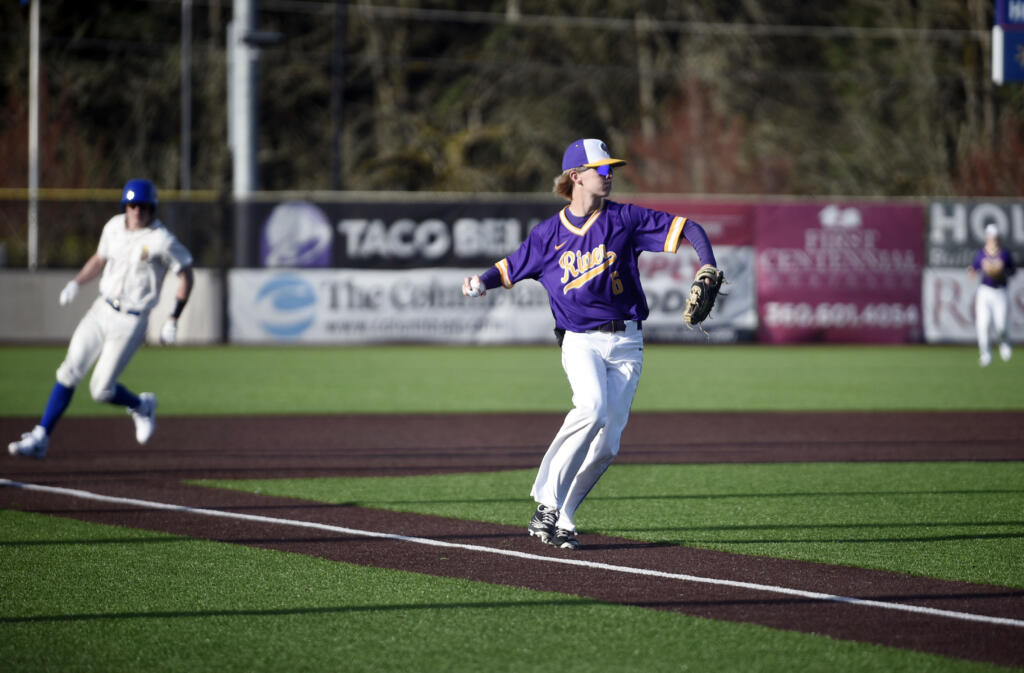Columbia River third baseman Nate Little (6) turns to throw to first base for an out against Ridgefield during a 2A GSHL baseball game on Friday, March 29, 2024, at Ridgefield Outdoor Recreation Complex.