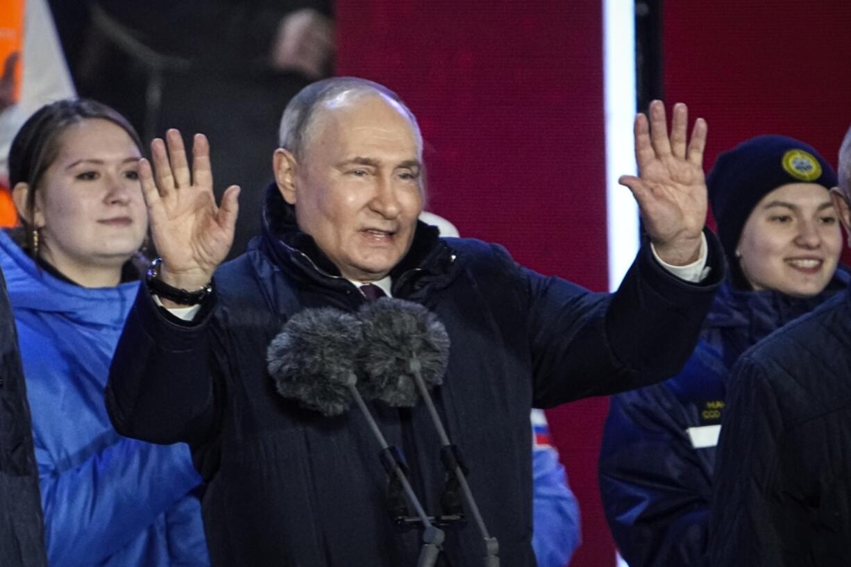 Russian President Vladimir Putin gestures while addressing a crowd at a concert marking his victory in a presidential election and the 10-year anniversary of Crimea&rsquo;s annexation by Russia on Red Square in Moscow, Russia, Monday, March 18, 2024. President Vladimir Putin seized Crimea from Ukraine a decade ago, a move that sent his popularity soaring but was widely denounced as illegal.