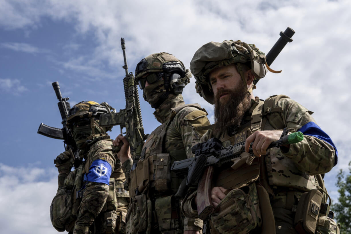 FILE - Fighters of Russian Volunteer Corps stand atop on an APC during press conference not far from the Ukraine&rsquo;s border with Russia in Sumy region, Ukraine, on May 24, 2023. Fighters from Ukraine made an attempt to cross into the town of Tetkino, which lies right on the border, the governor of Russia&rsquo;s Kursk region, Roman Starovoit, said Tuesday.