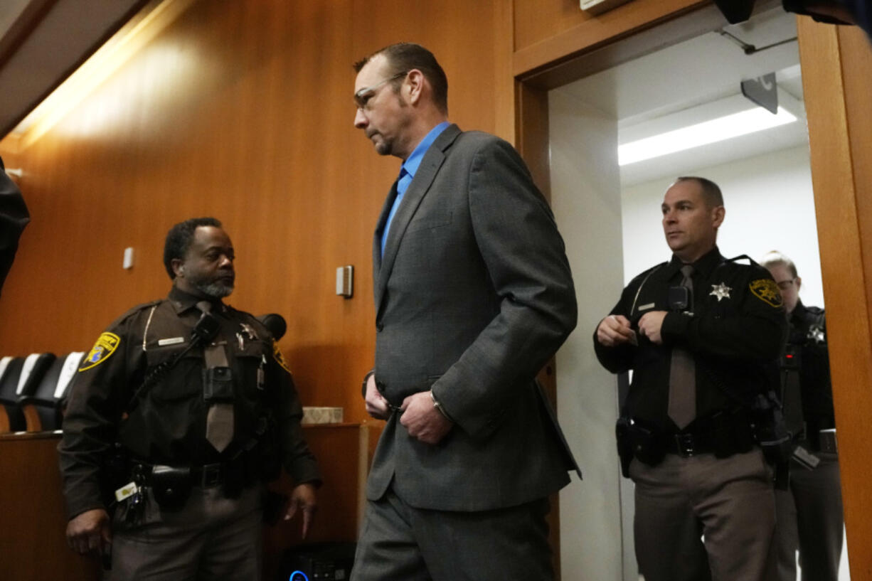 James Crumbley enters the Oakland County courtroom Friday, March 8, 2024, in Pontiac, Mich. Crumbley is on trial for involuntary manslaughter. He&rsquo;s accused of contributing to the tragedy at Oxford High School by failing to properly secure a gun used by son Ethan Crumbley. Four students were killed and more were wounded.