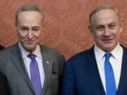 FILE - Israeli Prime Minister Benjamin Netanyahu, right, poses for a picture with Senate Minority Leader Chuck Schumer of New York, on Capitol Hill in Washington, Feb. 15, 2017. Schumer is calling on Israel to hold new elections. Schumer says he believes Israeli Prime Minister Benjamin Netanyahu has &ldquo;lost his way&rdquo; amid the Israeli bombardment of Gaza and a growing humanitarian crisis there. Schumer is the first Jewish majority leader in the Senate and the highest-ranking Jewish official in the U.S..