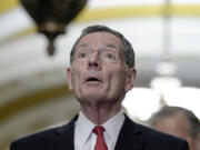 Senator John Barrasso, R-Wyo., left, talks after a policy luncheon on Capitol Hill Tuesday, Feb. 27, 2024, in Washington.