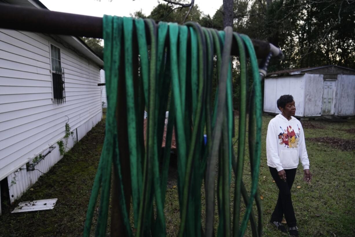 Angela Adams stands in the backyard of her home of 30 years on Tuesday, Dec. 5, 2023, in the Alabama Village neighborhood, in Prichard, Ala. There is talk of seizing residents&rsquo; property and paying them to move to help stem the city&rsquo;s water loss and create opportunities for redevelopment.