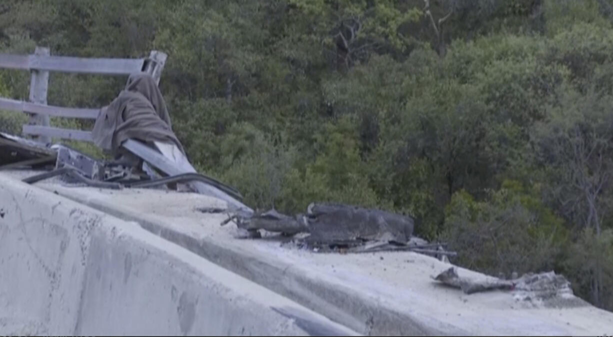 In this image taken from video provided by eNCA, a bus carrying worshippers headed to an Easter festival plunged off a bridge on a mountain pass and burst into flames in Limpopo, South Africa, on Thursday, March 28, 2024, killing multiple people, authorities said.