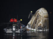 Support teams work around the SpaceX Dragon Endurance spacecraft shortly after it landed with NASA astronaut Jasmin Moghbeli,  European Space Agency astronaut Andreas Mogensen, Japan Aerospace Exploration Agency astronaut Satoshi Furukawa, and Russia cosmonaut Konstantin Borisov aboard in the Gulf of Mexico off the coast of Pensacola, Fla., Tuesday, March 12, 2024.