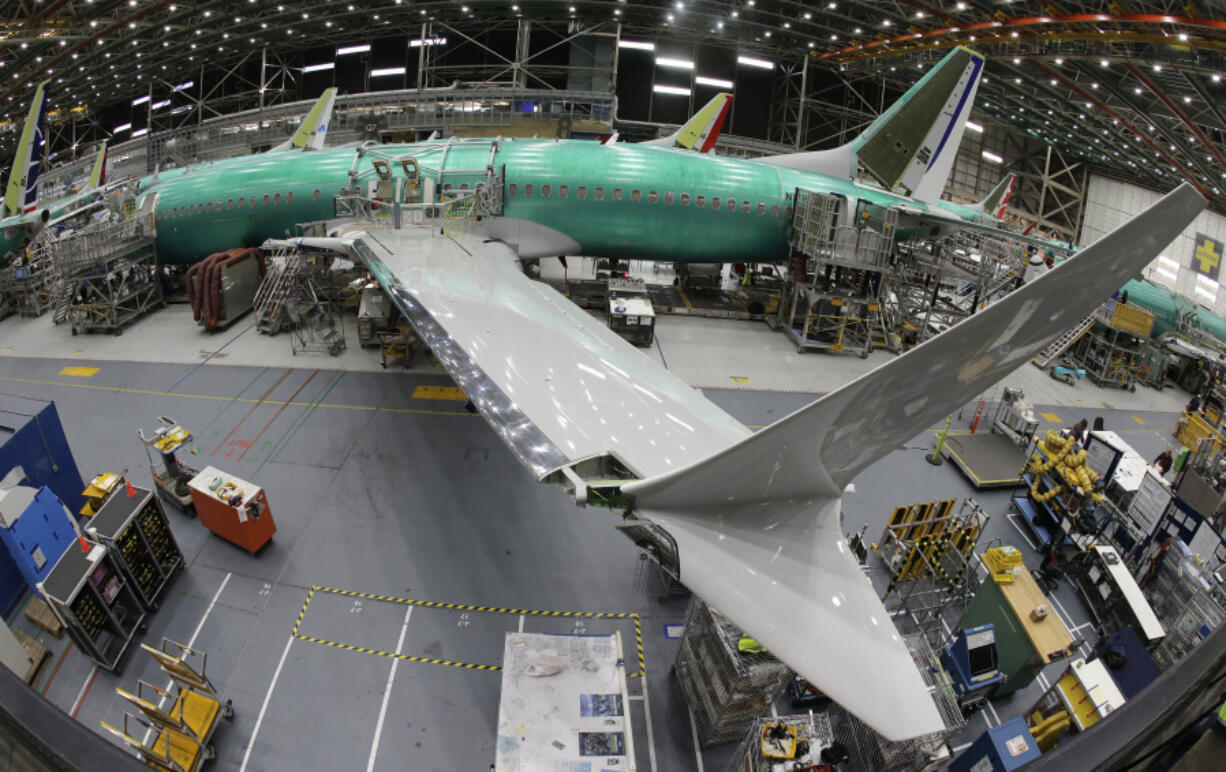 FILE - In this photo taken with a fish-eye lens, a Boeing 737 MAX 8 airplane sits on the assembly line during a brief media tour in Boeing&rsquo;s 737 assembly facility in Renton, Wash., March 27, 2019. Boeing is in talks to buy Spirit AeroSystems, which builds fuselages for Boeing 737 Max jetliners including the one that suffered a door-panel blowout in January, according to a published report, Friday, March 1, 2024. (AP Photo/Ted S.