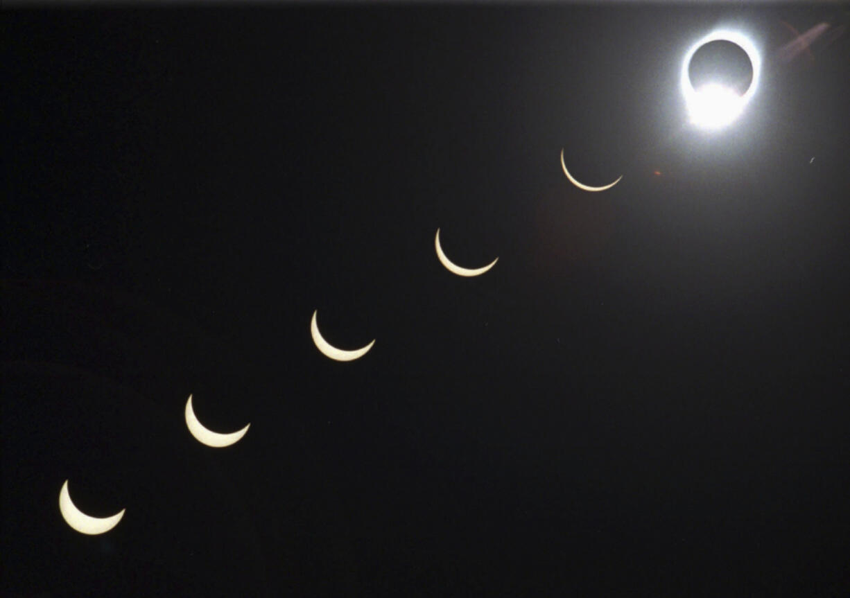 FILE - The progression of a total solar eclipse is seen in a multiple exposure photograph taken in 5-minute intervals, with the moon passing in front of the sun above Siem Reap in northwestern Cambodia, 225 kilometers (140 miles) from Phnom Penh, on Tuesday, Oct. 24, 1995.