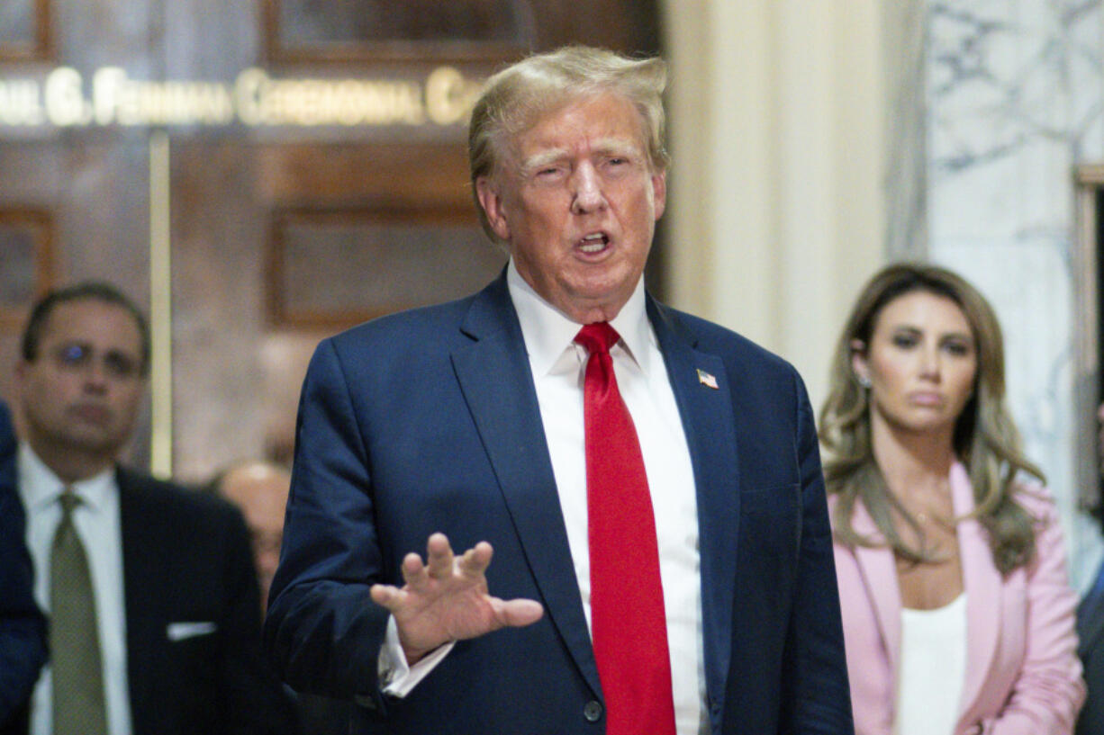 FILE - Former President Donald Trump speaks after exiting the courtroom for a break at New York Supreme Court, Dec. 7, 2023, in New York. New York State Lawyers urged an appeals court Wednesday, March 20, 2024,  not to buy Trump&rsquo;s claims that he cannot find a way to post a bond fully covering a $454 million civil fraud judgment while he appeals.