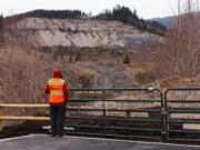 Michael Grilliot, senior research scientist and operations manager, watches a drone flying over the Oso landslide as part of the Natural Hazards Engineering Research Infrastructure RAPID Facility, funded by the National Science Foundation, Friday, March 8, 2024. The team was scouting in preparation of a "production" LiDAR drone flight scheduled for the following week, designed to monitor the landslide's changes.