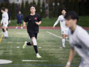 King's Way Christian junior Luke Gomes, left, cuts toward the ball during a boys soccer game against Seton Catholic on March 21 in Vancouver.