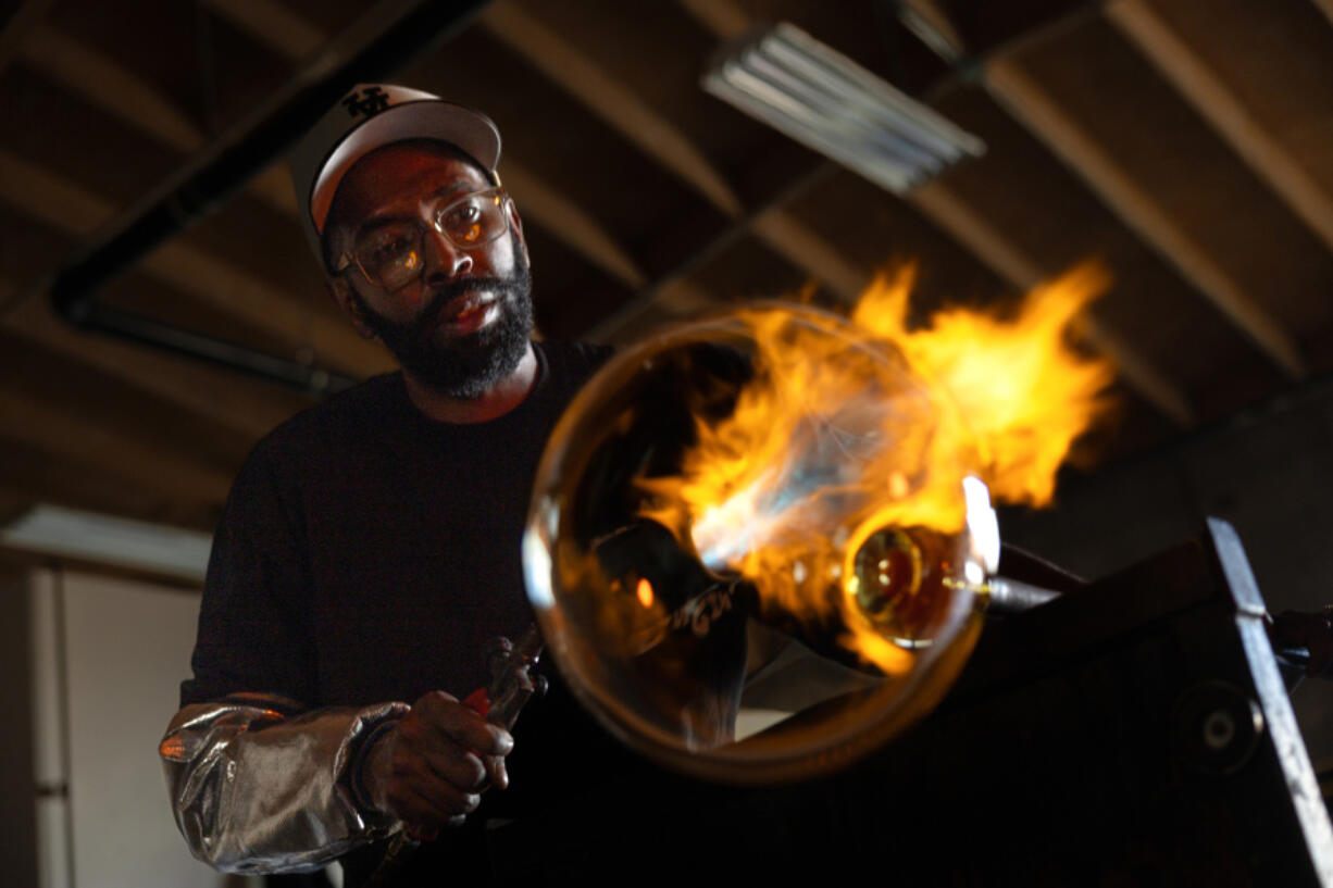 Glassblower Cedric Mitchell at work Feb. 21 in his El Segundo studio in California.