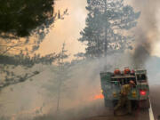 Firefighters battle a wildfire in August 2021 near Greenwood Lake in the Superior National Forest of northeastern Minnesota. Some oil companies are set to stand trial in lawsuits brought by local and state governments, including Minnesota, over the damages caused by climate change. (U.S.