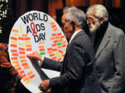 Anthony Silvestre, left, with August Pusateri, contributes to a poster remembering those lost on World AIDS Day in 2015 at Heinz Chapel and sponsored by the Pitt Men&rsquo;s Study.