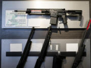 A semi-automatic rifle is displayed above shotguns at Rainier Arms Friday, April 14, 2023, in Auburn, Wash. A Cowlitz County judge ruled Washington’s ban on high-capacity magazines unconstitutional Monday, but just minutes later the state Supreme Court issued an emergency order keeping the law on the books while the state appeals the decision.