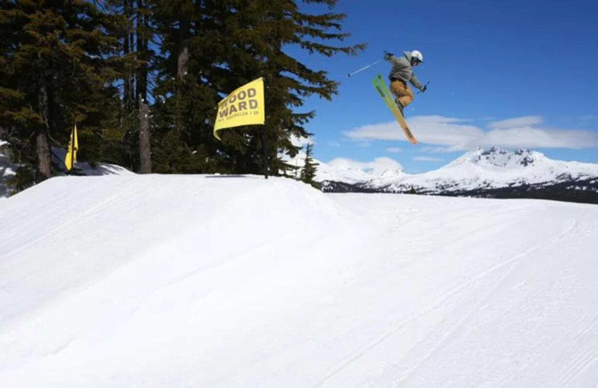 A skier floats over the Central Oregon Cascades while launching a 360 in the Woodward Terrain Park near the Skyliner lift at Mt. Bachelor.