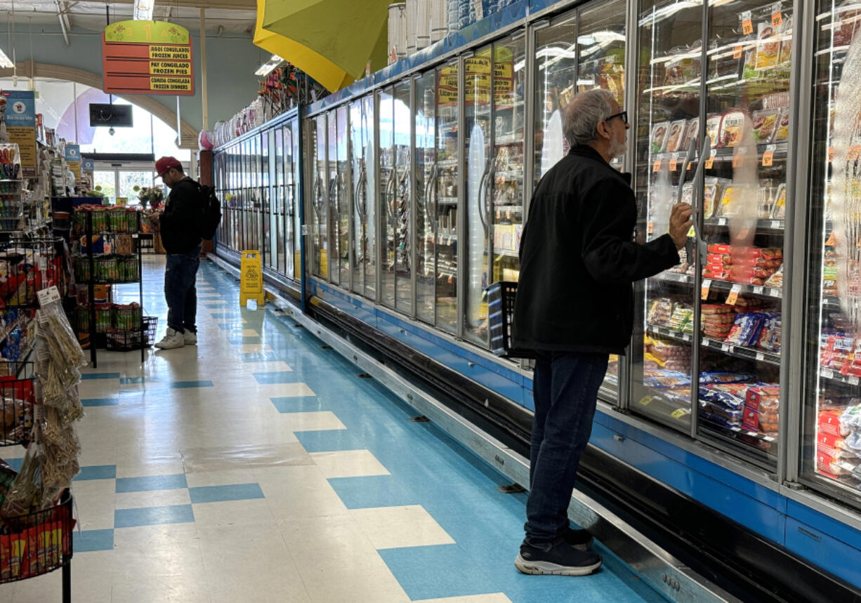 A customer shops for food at a grocery store on March 12, 2024, in San Rafael, California.