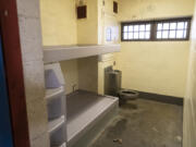 Beds, a toilet and sink sit inside a jail cell at the Clark County Jail.