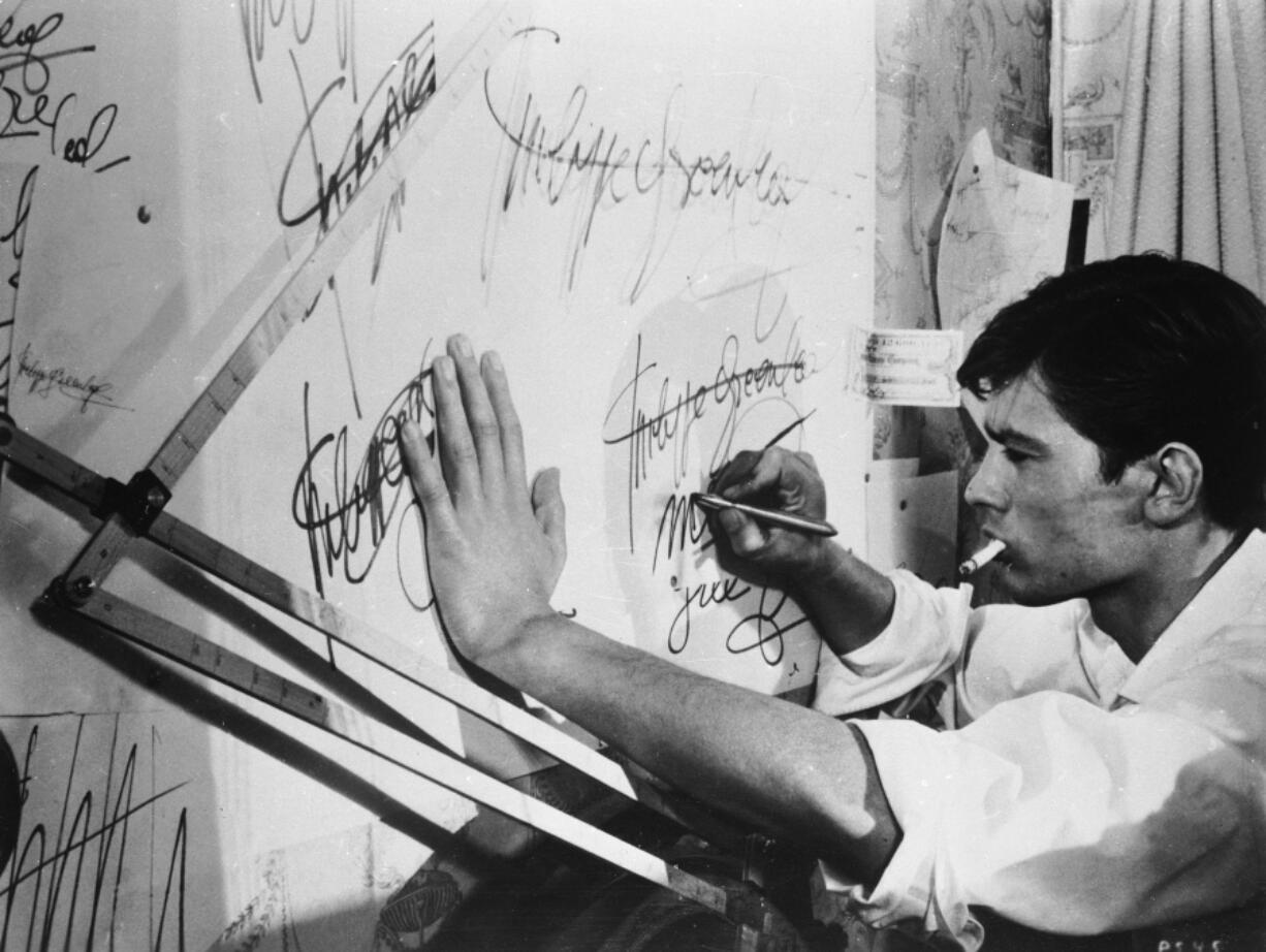 French actor Alain Delon practices forging a signature in the 1960 film &ldquo;Purple Noon,&rdquo; based on the Patricia Highsmith novel &ldquo;The Talented Mr.