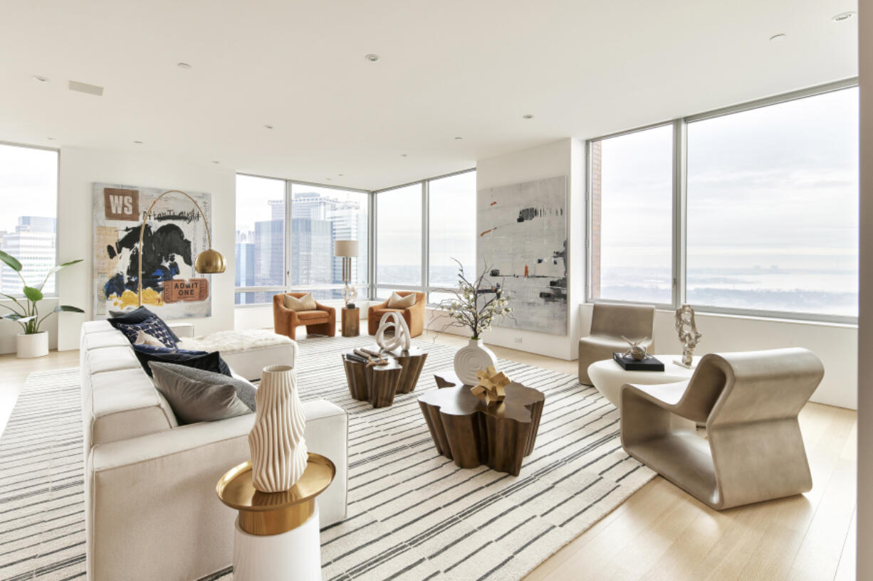 A large living room is grounded using an oversized area rug.