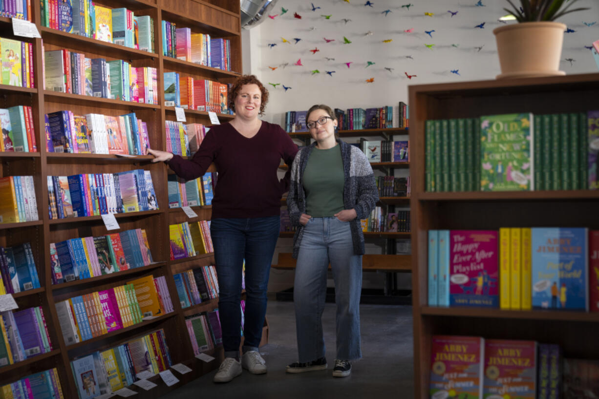 Lauren Richards, left, and Caitlin O&rsquo;Neil, co-owners of romance bookstore Tropes &amp; Trifles, pose for portrait inside their bookstore in Minneapolis, Minn., on April 4.