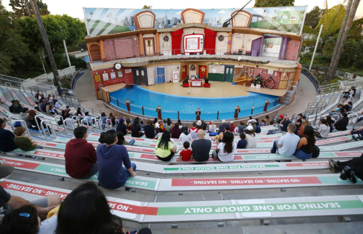 Patrons watch a holiday show featuring sea lions Clyde and Seamore in a spoof of a nighttime television Christmas special at Sea World San Diego on Nov. 16, 2020, in San Diego, Calif. (K.C.