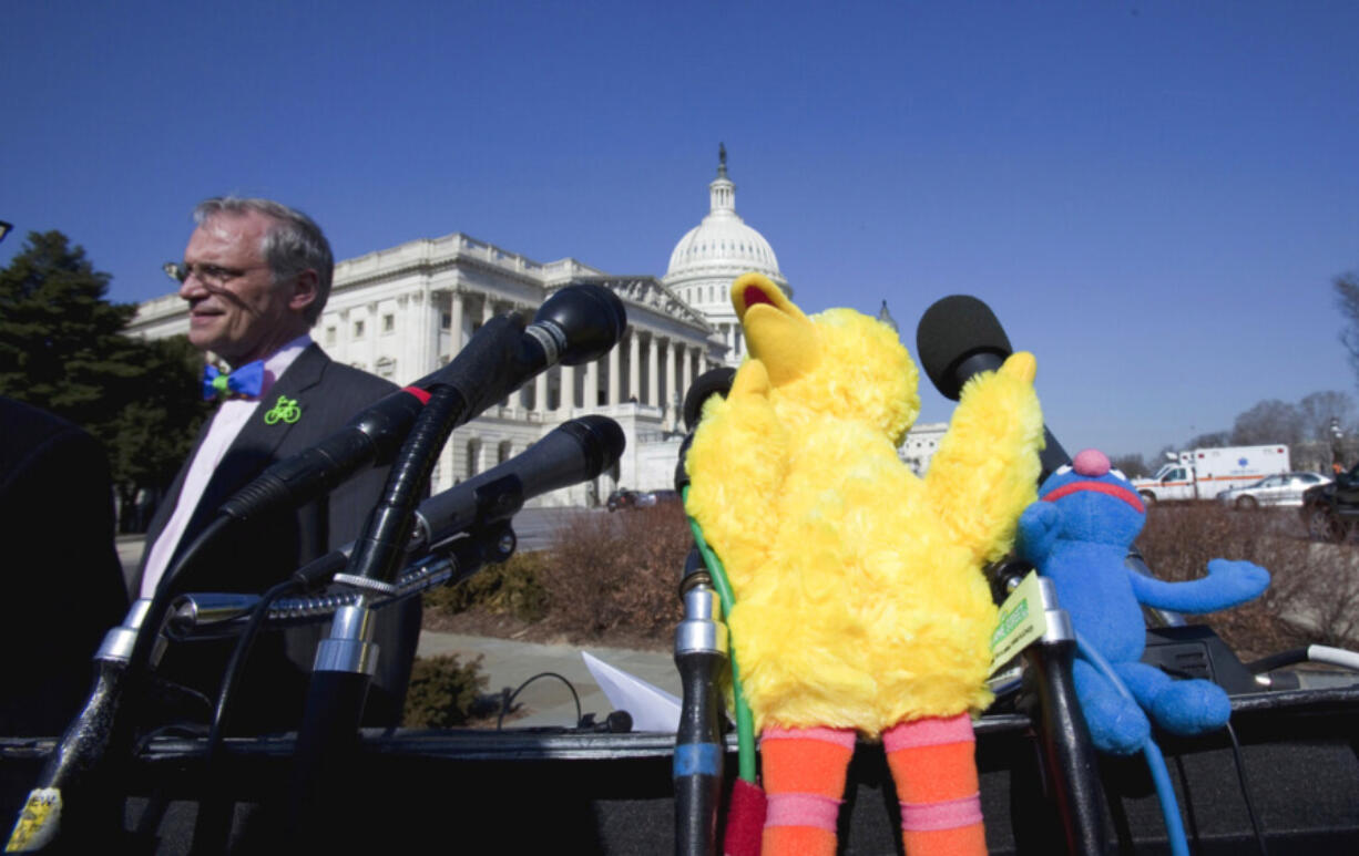 Rep. Earl Blumenauer, D-Ore., left, accompanied by Big Bird and Grover puppets, takes part in a news conference on Capitol Hill in Washington, Wednesday, Feb. 16, 2011, to discuss the future of Public Broadcasting.