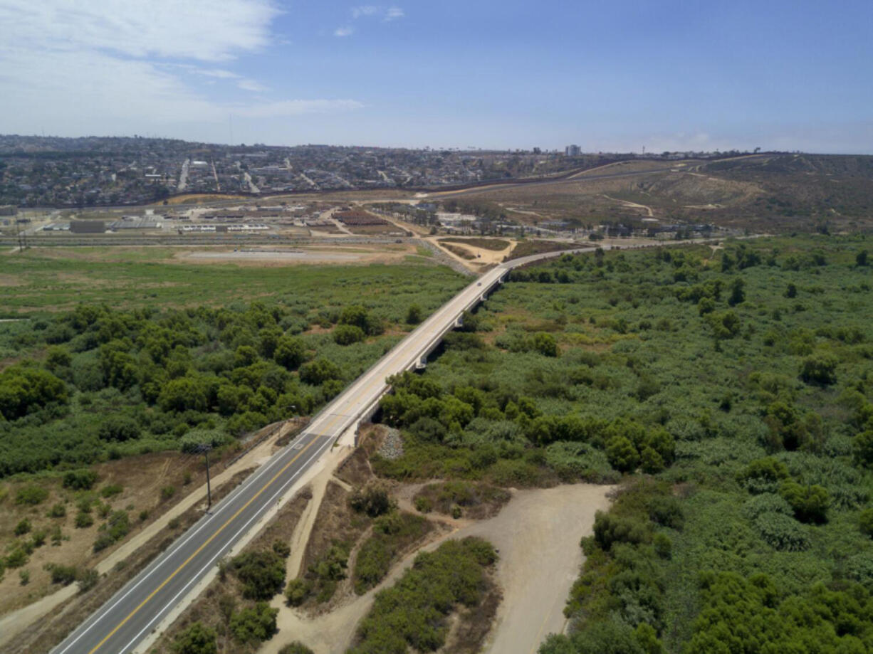 A section of Dairy Mart Road that bridges over the Tijuana River in south San Diego with the U.S.-Mexico border in the background. A new report on the country&rsquo;s endangered rivers comes months after the Mexican government recognized Tijuana as having some of the most sewage-contaminated beaches in the country. (Nelvin C.