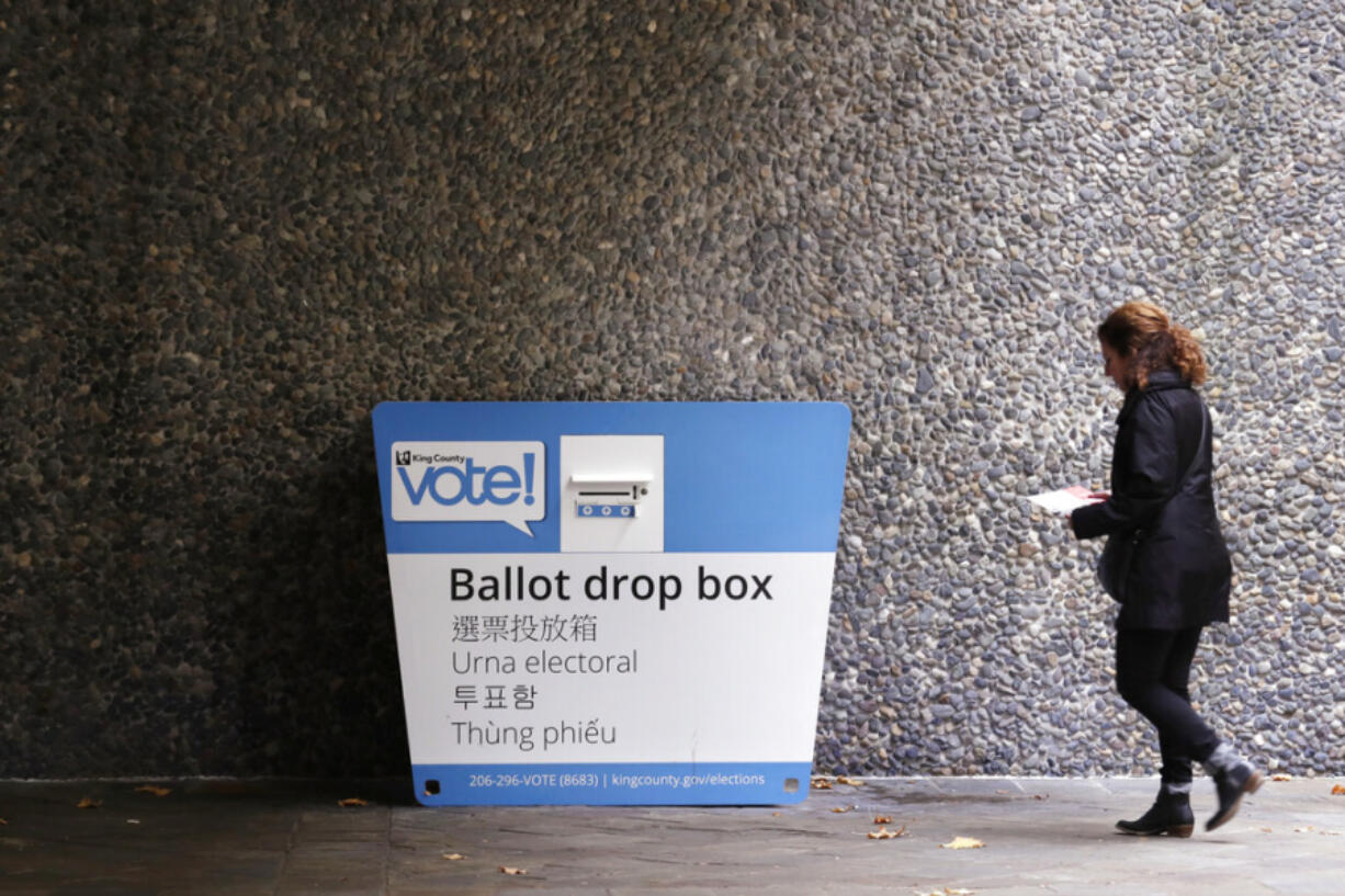 A voter heads to a ballot drop box Monday, Nov. 4, 2019, in Seattle. Voters in Washington state have a crowded ballot to fill out for this week&rsquo;s election, with a referendum on affirmative action and an initiative on the price of car tabs among the things they are being asked to decide.