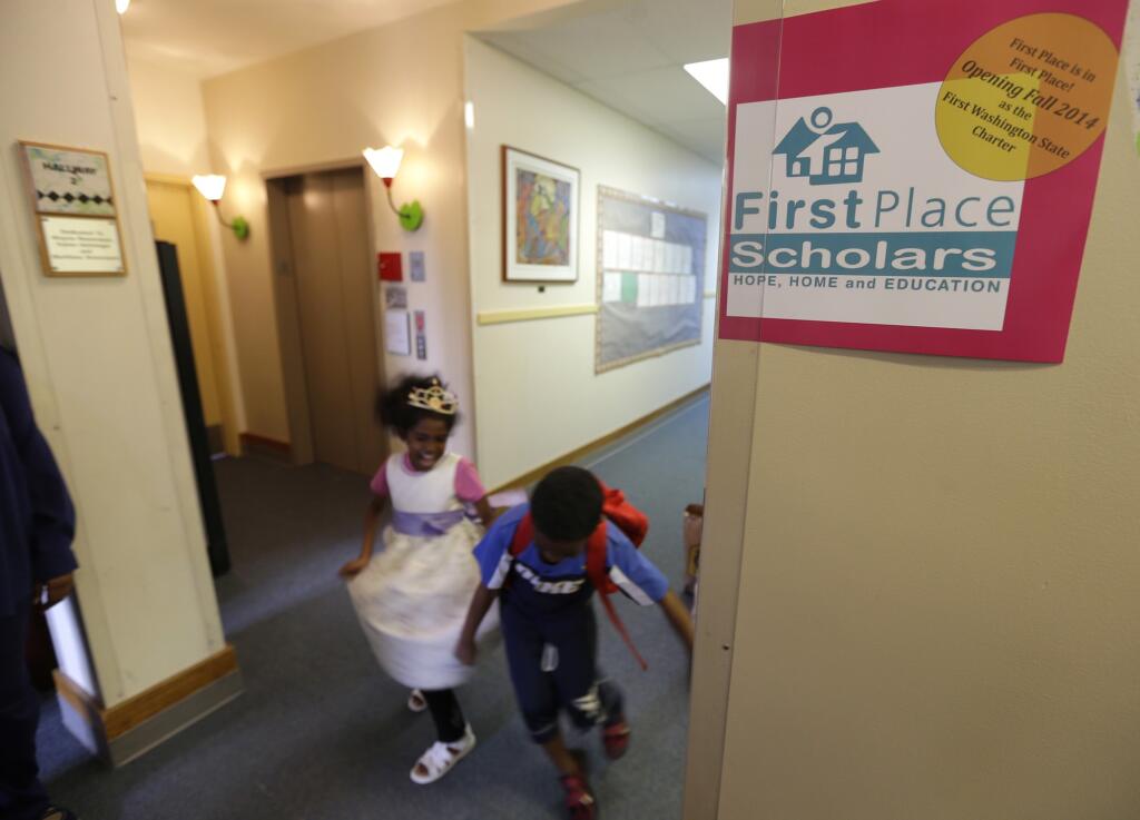 Students walk through a hallway at  First Place Scholars Charter School, Washington's first charter school, in Seattle. Washington’s charter school students are scoring similar or better than their traditional public school peers, according to a new report released by the State Board of Education.