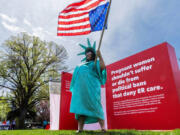 Jamie Richmond, Boise, dressed as a pregnant Statue of Liberty during a rally at the Idaho Capitol in Boise, Idaho, on Sunday, April 21, 2024. Hundreds gathered to support women and health care workers caught in the legal gray areas of Idaho&rsquo;s strict abortion legislation.