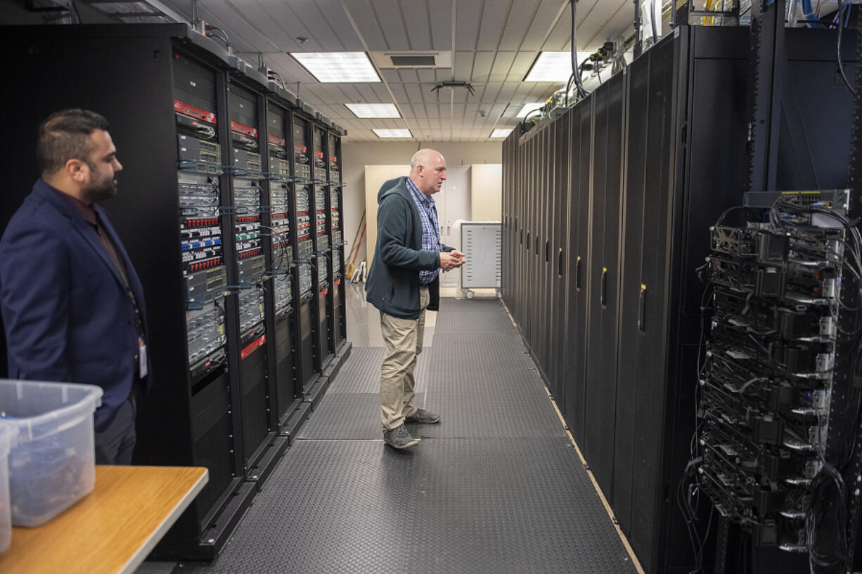 Mohammed &ldquo;Giga&rdquo; Alqeeq, left, and Dwight Hughes of Clark College tour the school&rsquo;s cybersecurity lab. As the cybercrime industry has boomed, the college&rsquo;s 4-year-old cybersecurity bachelor&rsquo;s program is now operating at capacity.