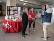 Deborah Alexander, from left, and Jen Barnett, volunteers with Shared Hope International, chat with La Center School District Superintendent Peter Rosenkranz before a presentation about online safety at La Center High School on Wednesday.