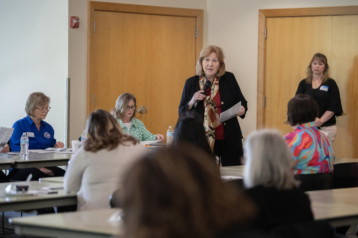 Vancouver Mayor Anne McEnerny-Ogle, standing, speaks to the group at a roundtable discussion about homelessness hosted by a group of healthcare agencies on Friday at the Water Resource Education Center in Vancouver.