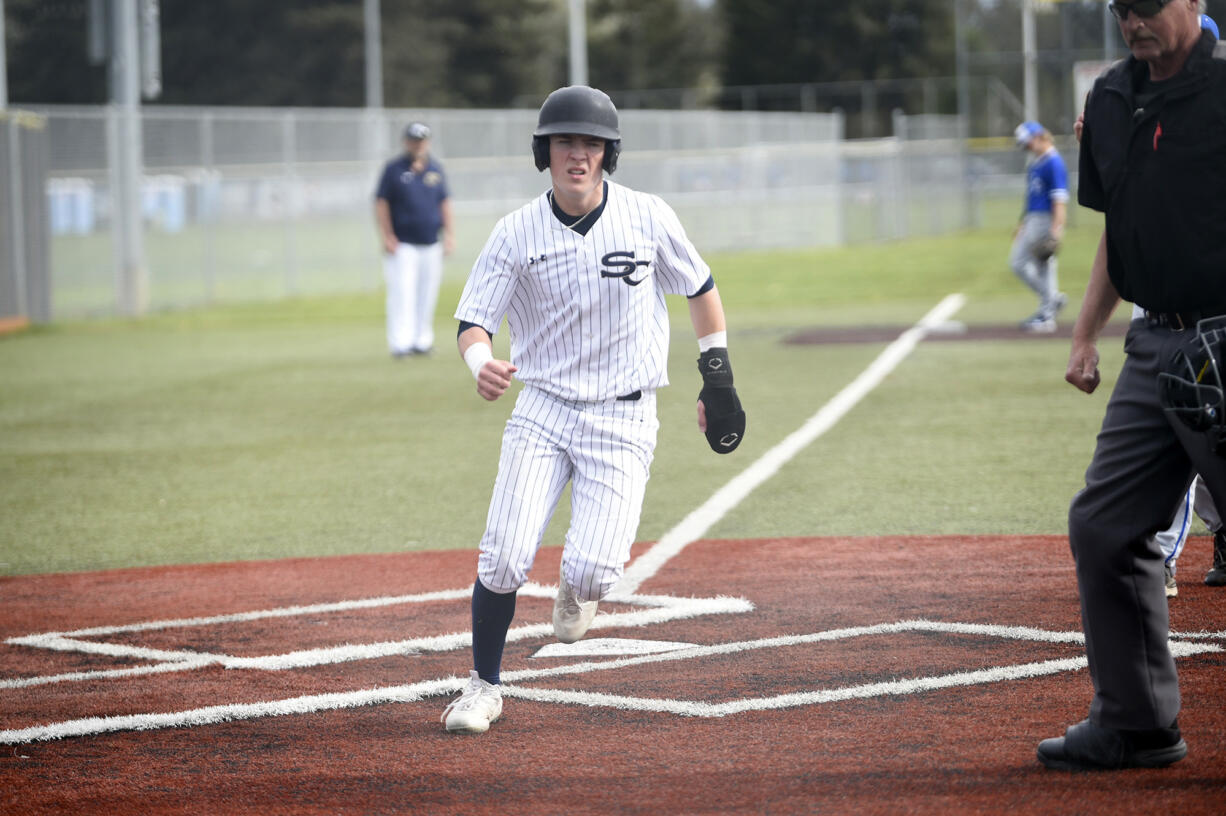 Teddy Wieczorek runs across home plante after scoring a run in the first inning of Seton Catholic's 8-4 loss to La Center in a Trico League baseball game at Harmony Sports Complex on Friday, April 12, 2024.