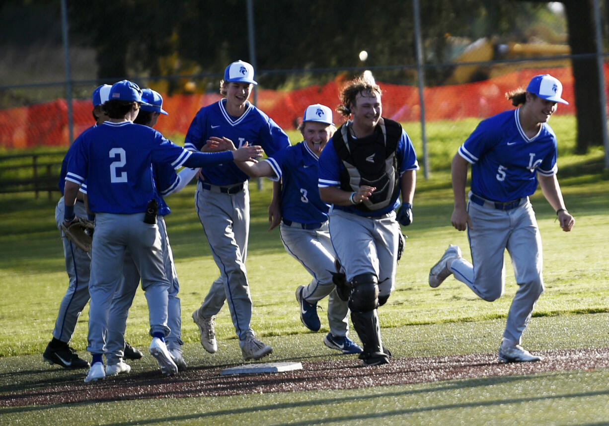 Members of the La Center baseball celebrate after beating Seton Catholic 8-4 in a Trico League game at Harmony Sports Complex on Friday, April 12, 2024.