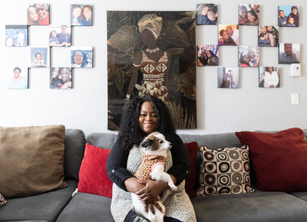 Inner Beauty in U founder Yolanda Merriweather sits with her 12-year-old dog, Ally, for a portrait on Tuesday at Merriweather&rsquo;s apartment.