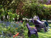 Debbie Kogan of Portland takes in the beauty at Hulda Klager Lilac Gardens while soaking up the sunshine.