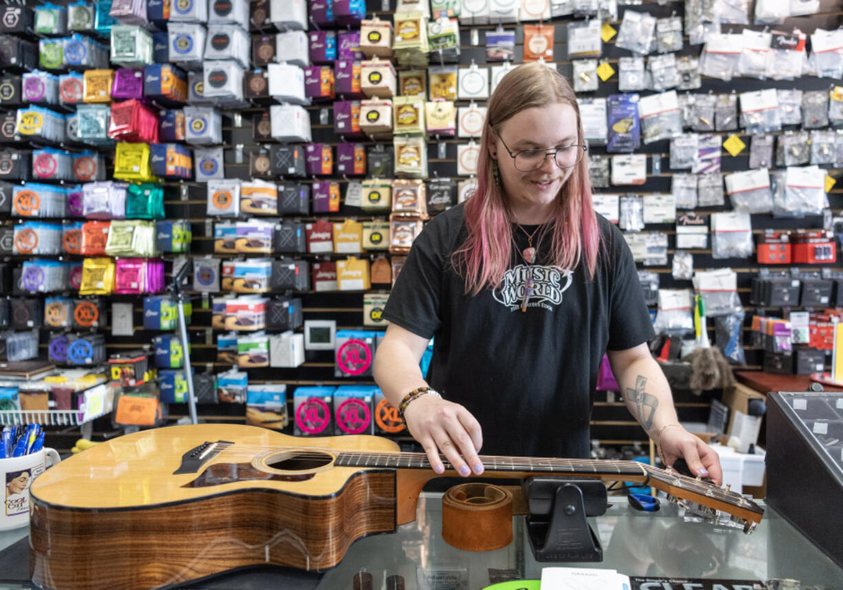 *LEADOPTION* Music World in Hazel Dell on Thursday hosted a free musical instrument string exchange where people could get new strings and their instrument restrung while supplies lasted.