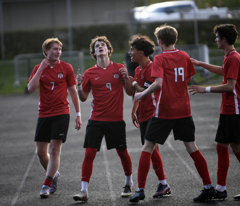 Cooper Schneider (9) of Camas celebrates his first-half goal with teammates during a 4A Greater St. Helens League boys soccer match against Union at Doc Harris Stadium in Camas on Monday, April 29, 2024.