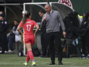 Portland Thorns FC head coach Mike Norris talks with midfielder Sam Coffey (17) during an NWSL soccer match against NJ/NY Gotham FC, Sunday, March 24, 2024, in Portland, Ore.