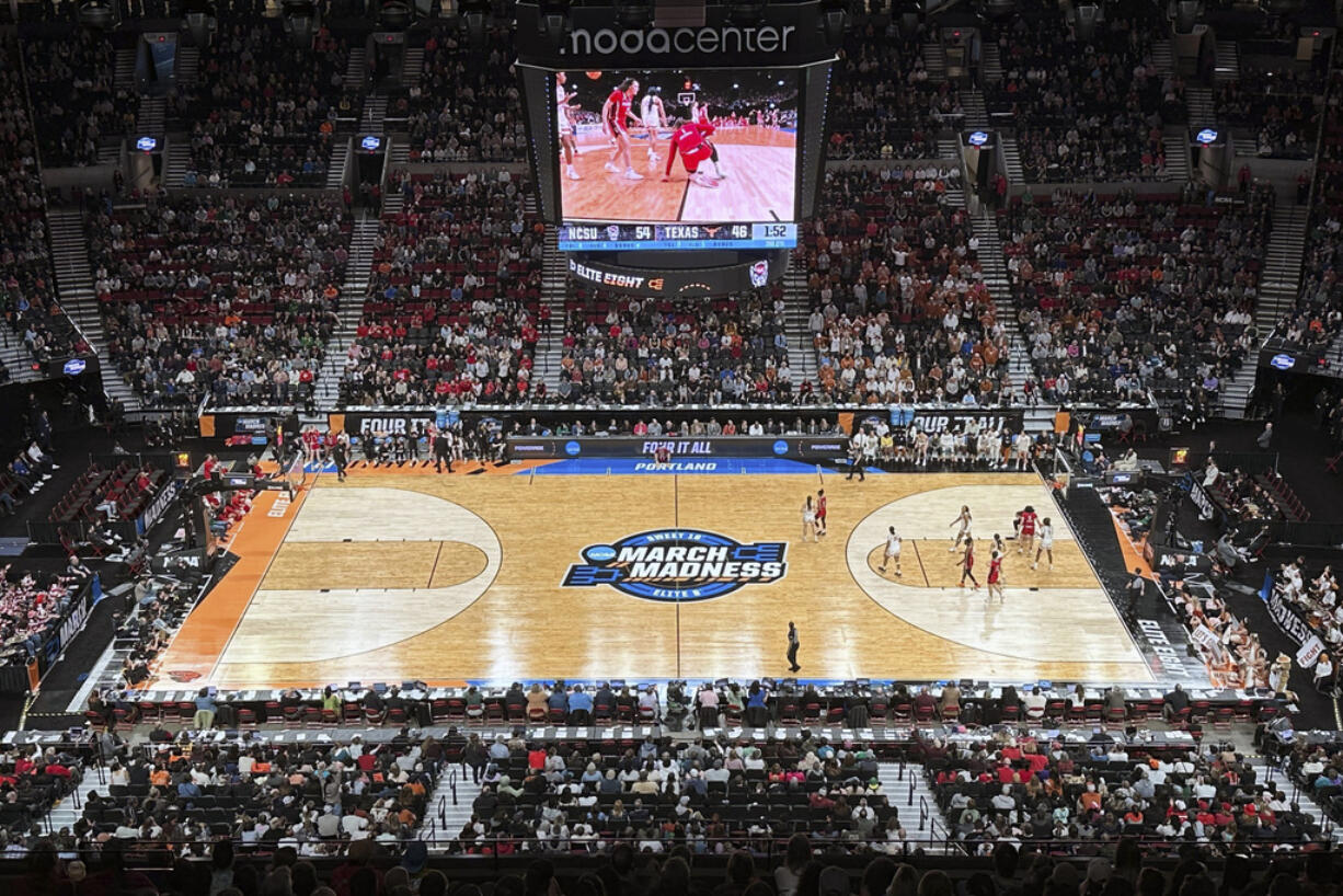 Texas and North Carolina State play during the second half of an Elite Eight college basketball game in the women's NCAA Tournament, Sunday, March 31, 2024, in Portland, Ore. The 3-point line for the women's NCAA Tournament at Moda Center had a discrepancy in distance at each end of the court that went unnoticed through four games over two days before Texas and North Carolina State were informed of the problem ahead of their Elite Eight matchup on Sunday.