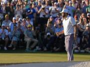 Scottie Scheffler celebrates after a birdie on the 18th hole during third round at the Masters golf tournament at Augusta National Golf Club Saturday, April 13, 2024, in Augusta, Ga.