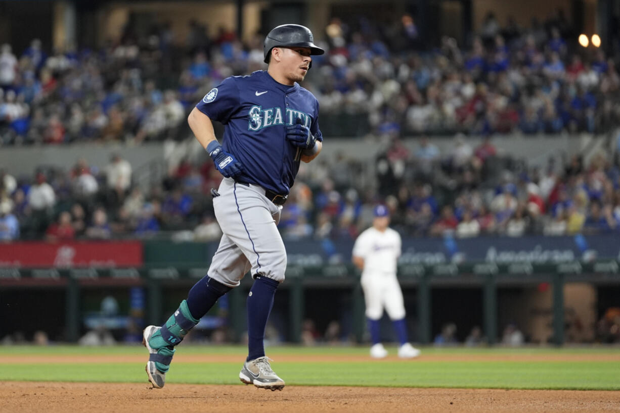 Seattle Mariners' Luis Urias rounds the bases after hitting a two-run home run in the fifth inning of a baseball game against the Texas Rangers in Arlington, Texas, Thursday, April 25, 2024. Dylan Moore also scored on the play.