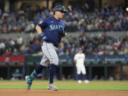 Seattle Mariners' Luis Urias rounds the bases after hitting a two-run home run in the fifth inning of a baseball game against the Texas Rangers in Arlington, Texas, Thursday, April 25, 2024. Dylan Moore also scored on the play.