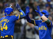 Seattle Mariners' Julio Rodríguez (44) greets Mitch Haniger, who hit a grand slam against the Arizona Diamondbacks during the sixth inning of a baseball game Friday, April 26, 2024, in Seattle.