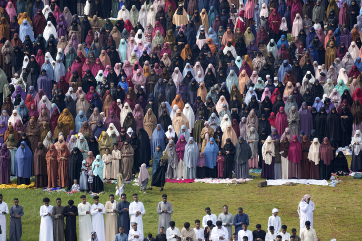 Muslim devotees, including women in the background, offer Eid al-Fitr prayers to mark the end of Ramadan, the Islamic holy month of fasting, in Nairobi, Kenya Wednesday, April. 10, 2024.