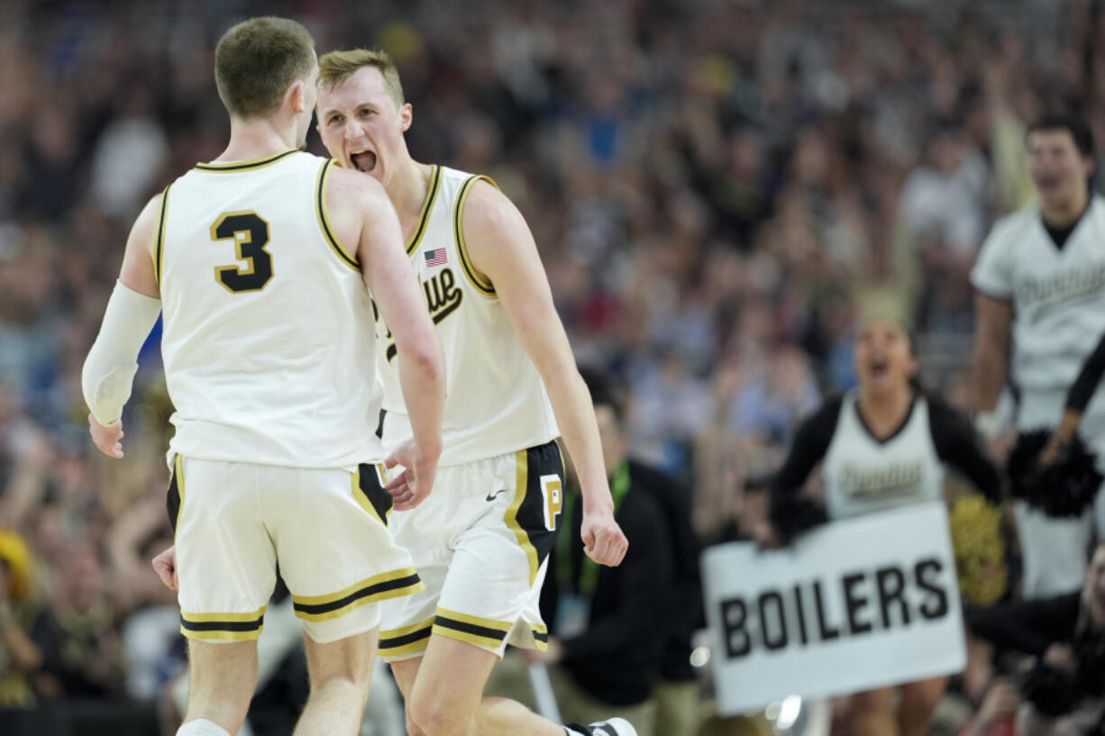 Purdue guard Fletcher Loyer (2) celebrates with guard Braden Smith (3) after scoring against North Carolina State during the second half of the NCAA college basketball game at the Final Four, Saturday, April 6, 2024, in Glendale, Ariz. (AP Photo/David J.