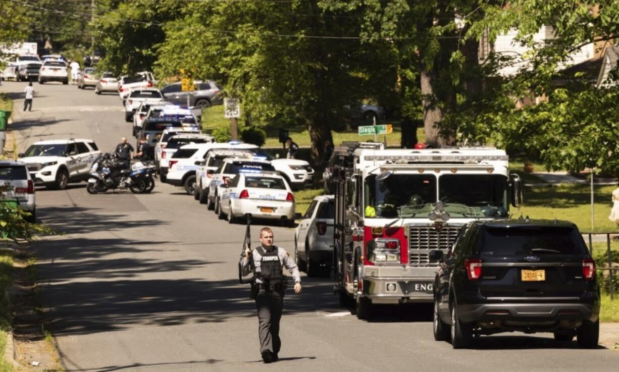 Multiple law enforcement vehicles respond in the neighborhood where several officers on a task force trying to serve a warrant were shot in Charlotte, N.C., Monday, April 29, 2024.