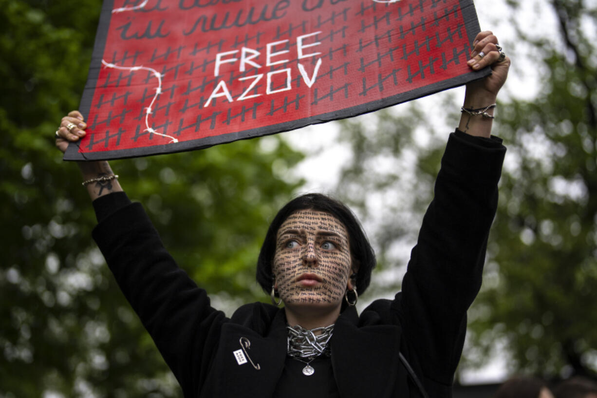 A woman holds a &quot;Free Azov&quot; sign during a rally aiming to raise awareness on the fate of Ukrainian prisoners of war in Kyiv, Ukraine, Sunday, April 21, 2024. The U.S. House of Representatives swiftly approved $95 billion in foreign aid for Ukraine, Israel and other U.S. allies in a rare Saturday session as Democrats and Republicans banded together after months of hard-right resistance over renewed American support for repelling Russia&#039;s invasion.