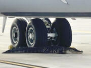 In this photo released by the MacDill Air Force Base, an alligator rests at the landing gear of a KC-135 aerial refueling aircraft on the runway of MacDill Air Force Base in Tampa, on Monday, April 22, 2024. Officers with the Florida Fish and Wildlife Conservation Commission responded and the alligator was moved and released in a nearby river.